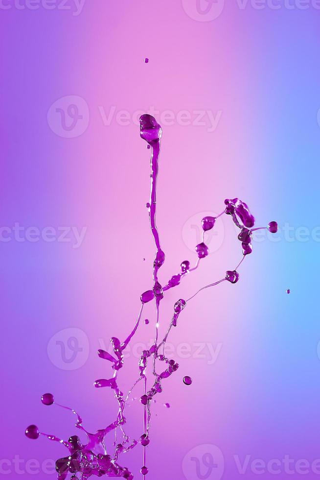 Abstract background of a splash of colored water, collision of colored drops falling towards each other. photo
