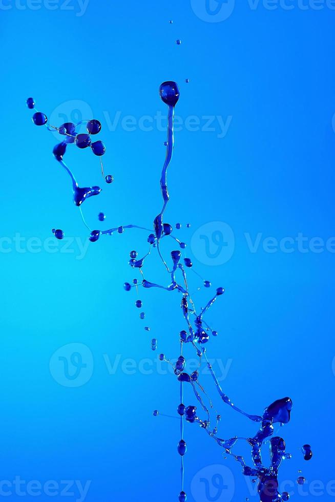 Abstract background of a splash of colored water, collision of colored drops falling towards each other. photo