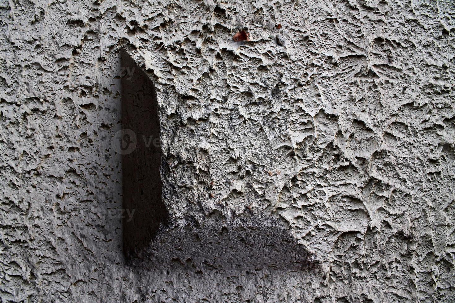 Detailed view on aged concrete walls with cracks and a lot of structure in high resolution photo