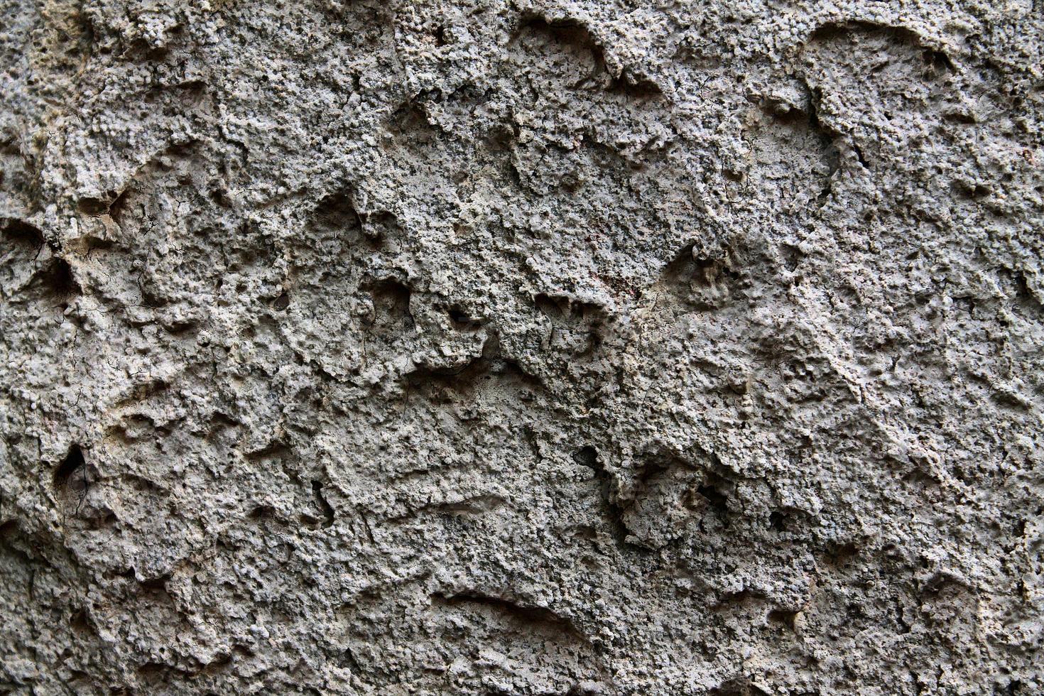 Detailed view on aged concrete walls with cracks and a lot of structure in high resolution photo