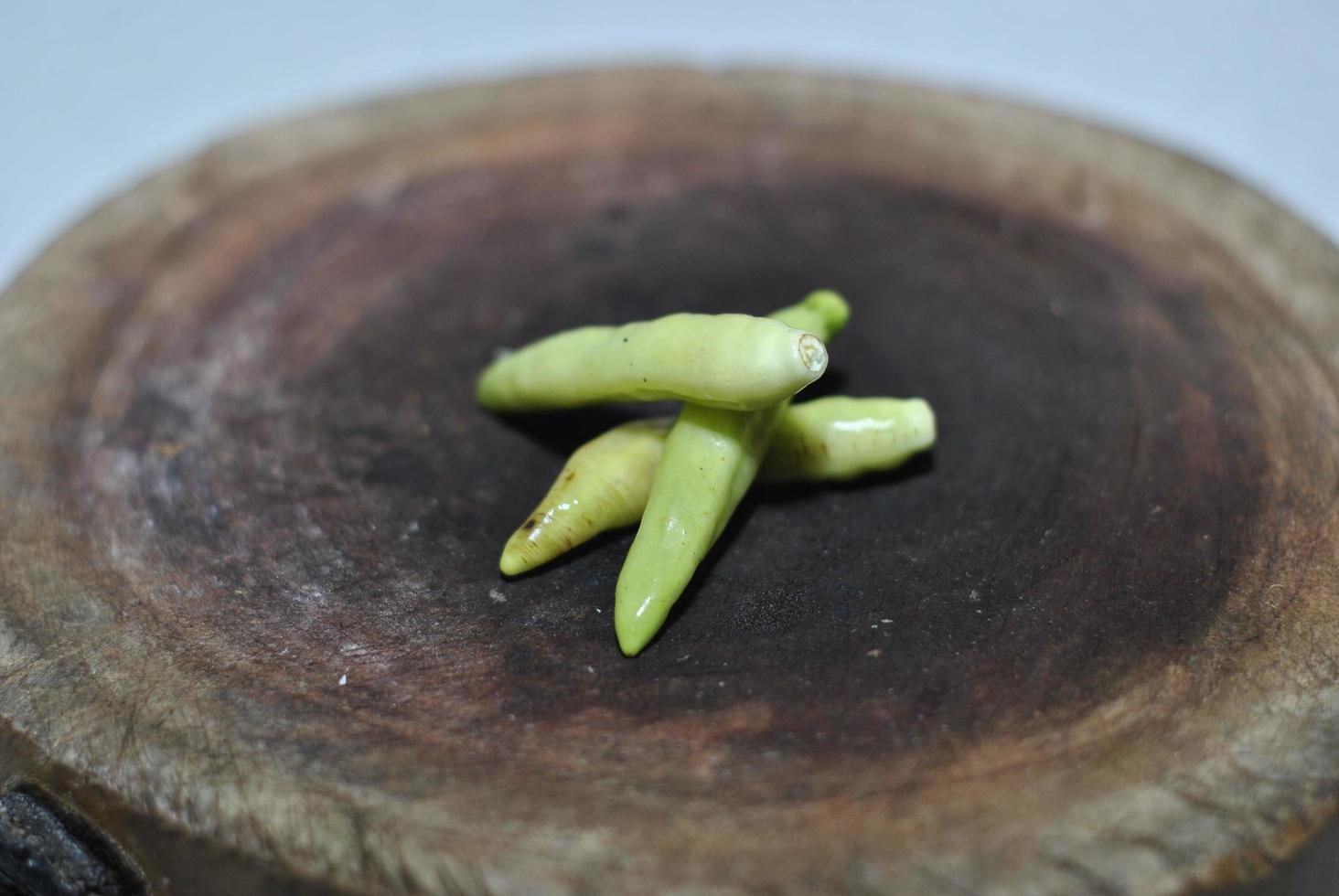 Spicy green chili with cutting board background photo