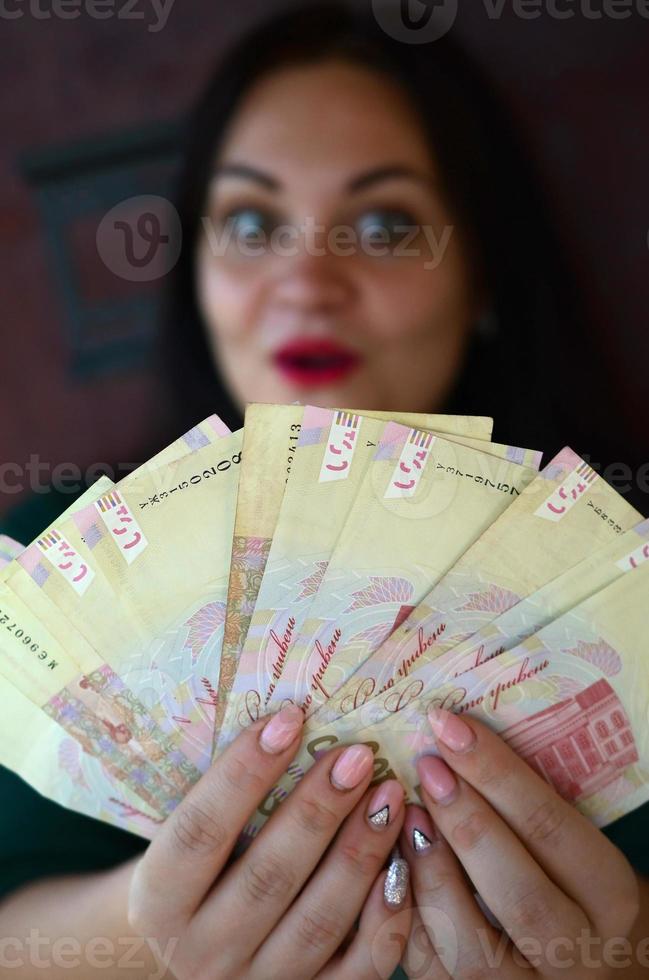 Brunette caucasian girl portrait with big amount of ukrainian money photo