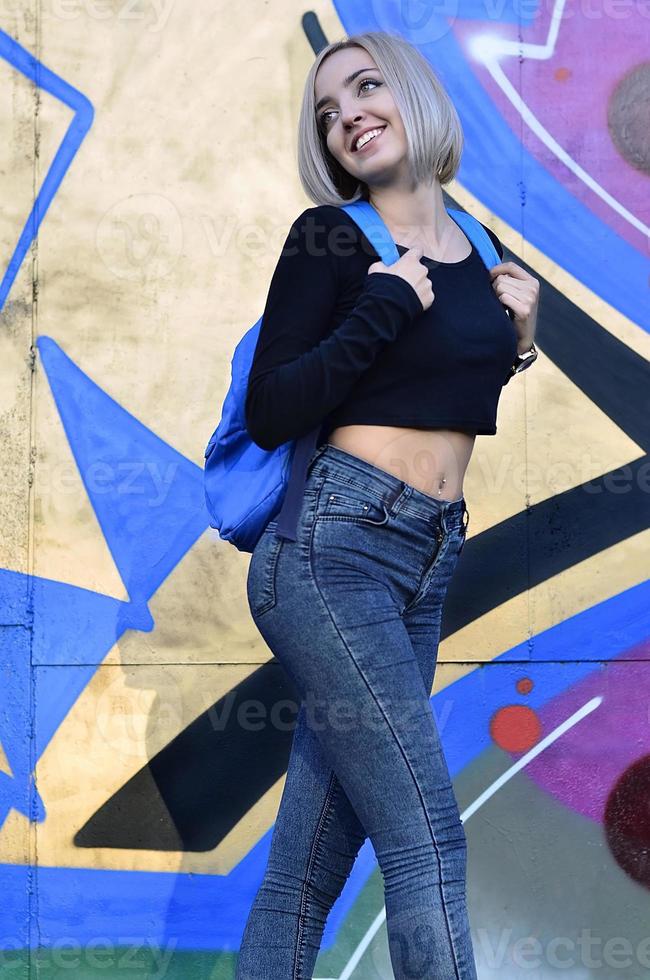 Portrait of a young blond girl with short hair on a background o photo