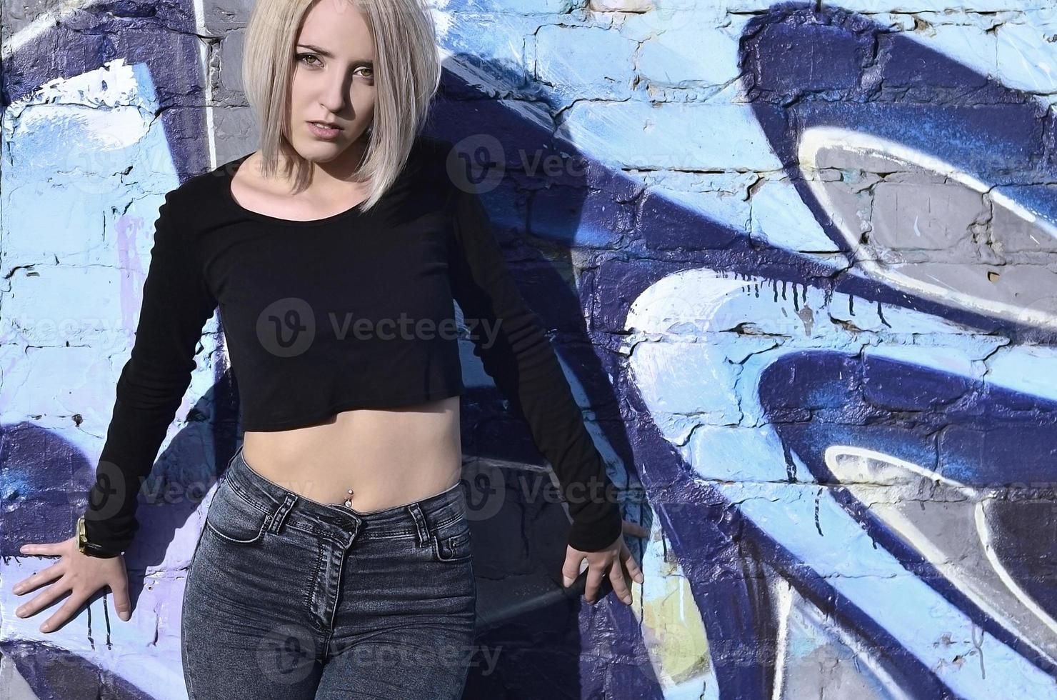Portrait of a young blond girl with short hair on a background o photo
