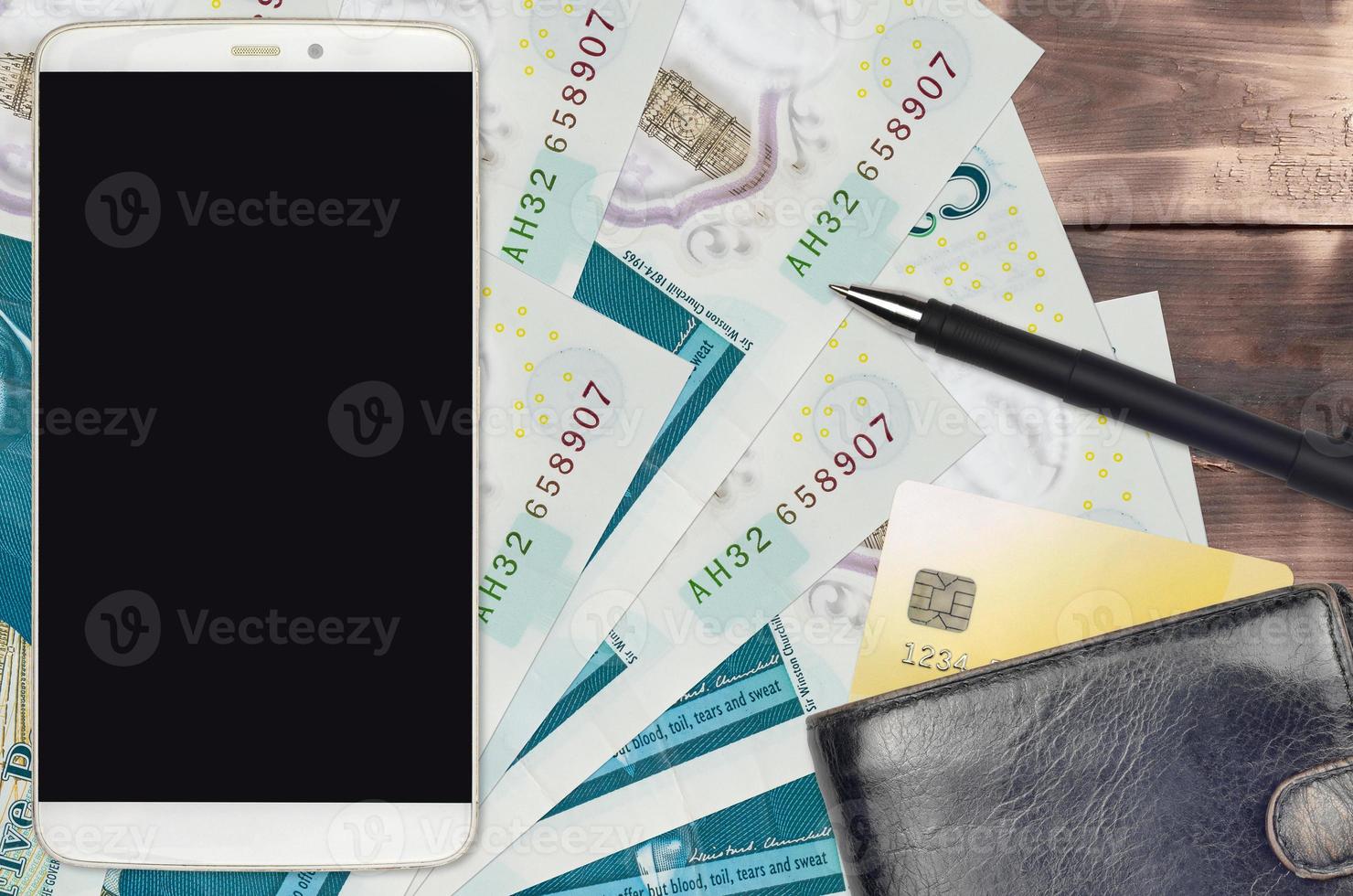 5 British pounds bills and smartphone with purse and credit card. E-payments or e-commerce concept. Online shopping and business with portable devices photo