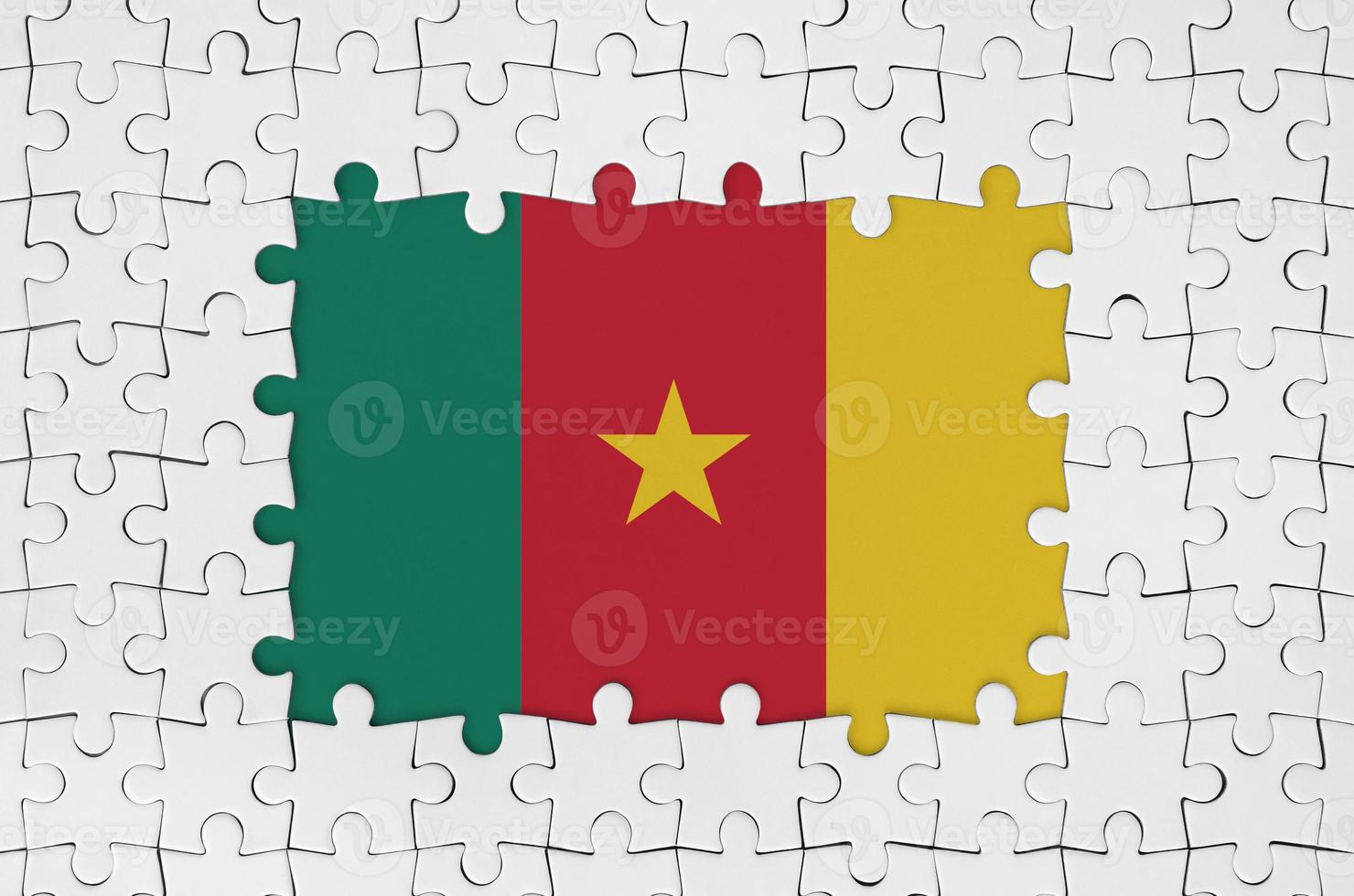 Cameroon flag in frame of white puzzle pieces with missing central part photo