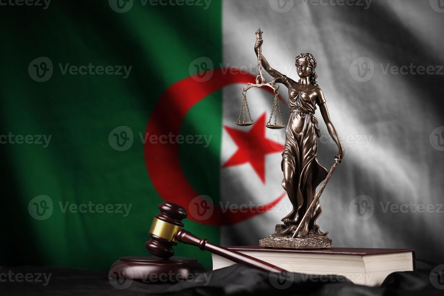 Algeria flag with statue of lady justice, constitution and judge hammer on black drapery. Concept of judgement and guilt photo