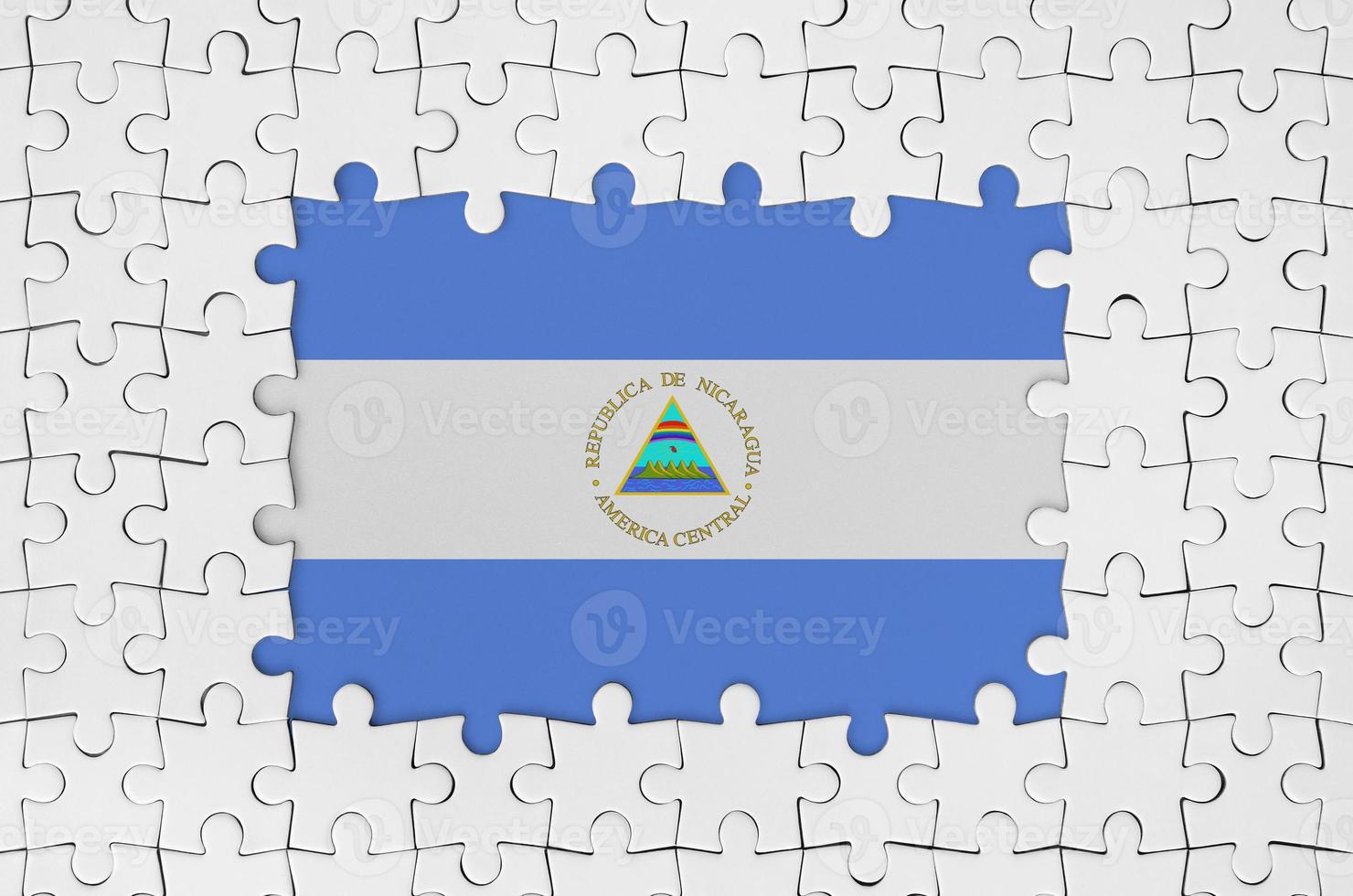 Nicaragua flag in frame of white puzzle pieces with missing central part photo