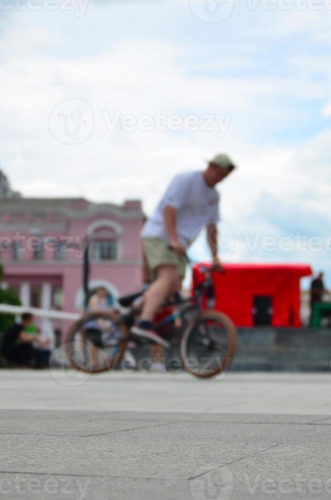 Defocused image of a lot of people with bmx bikes. Meeting of fans of extreme sports photo