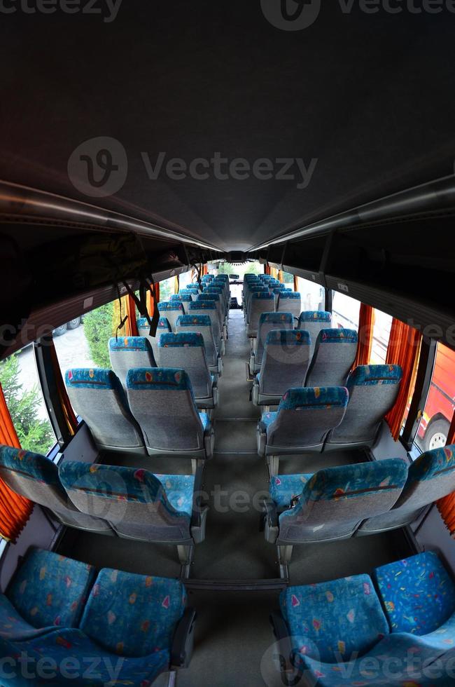 Interior of the tourist bus for excursions and long trips. A lot of free seats and places for small luggage photo