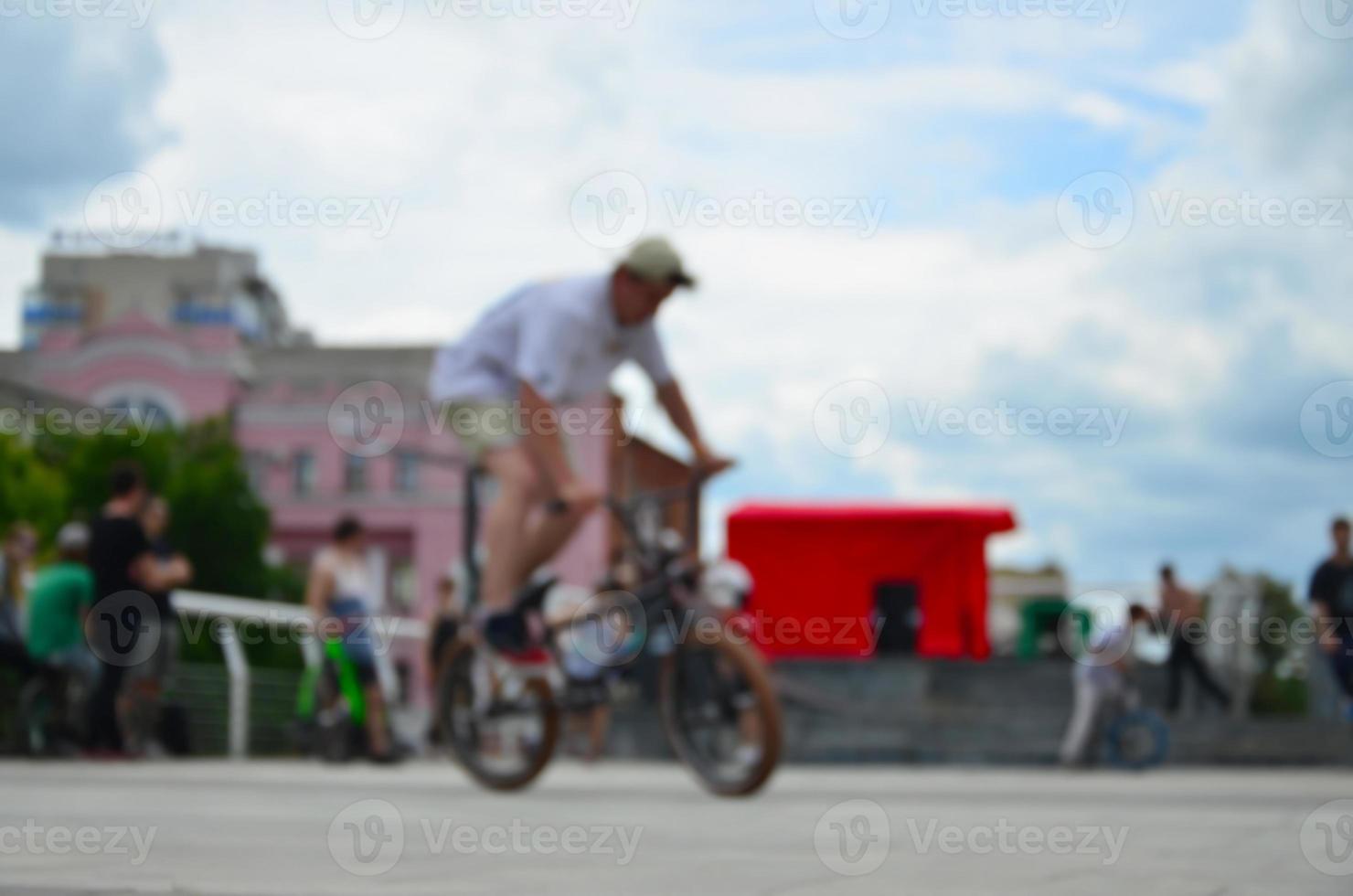 Defocused image of a lot of people with bmx bikes. Meeting of fans of extreme sports photo