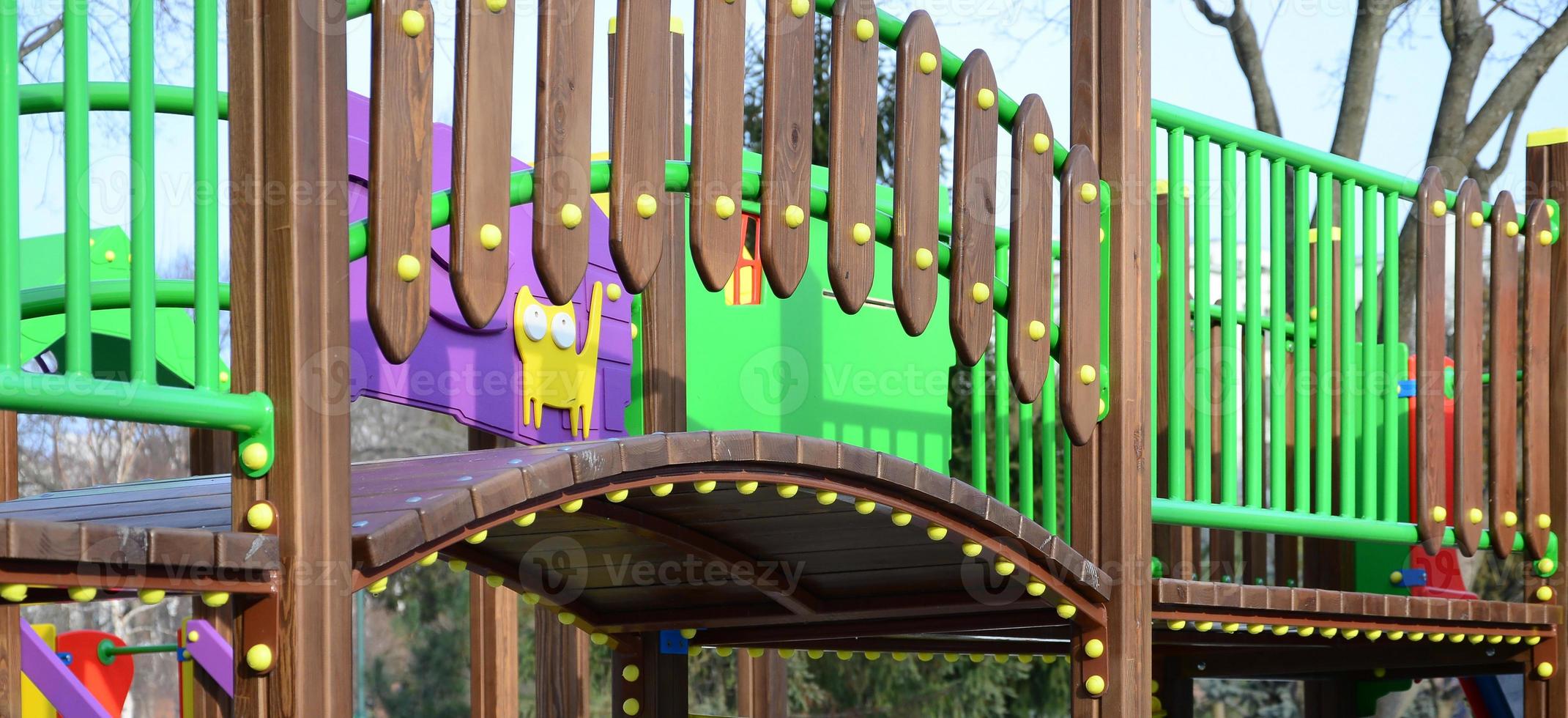 Fragment of a playground made of plastic and wood, painted in different colors photo
