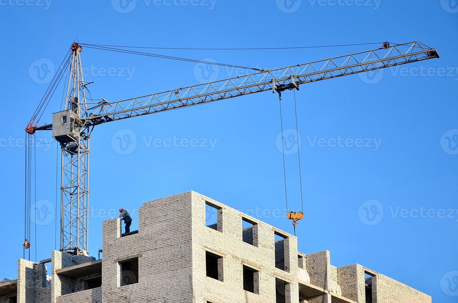 Building under construction with crane photo