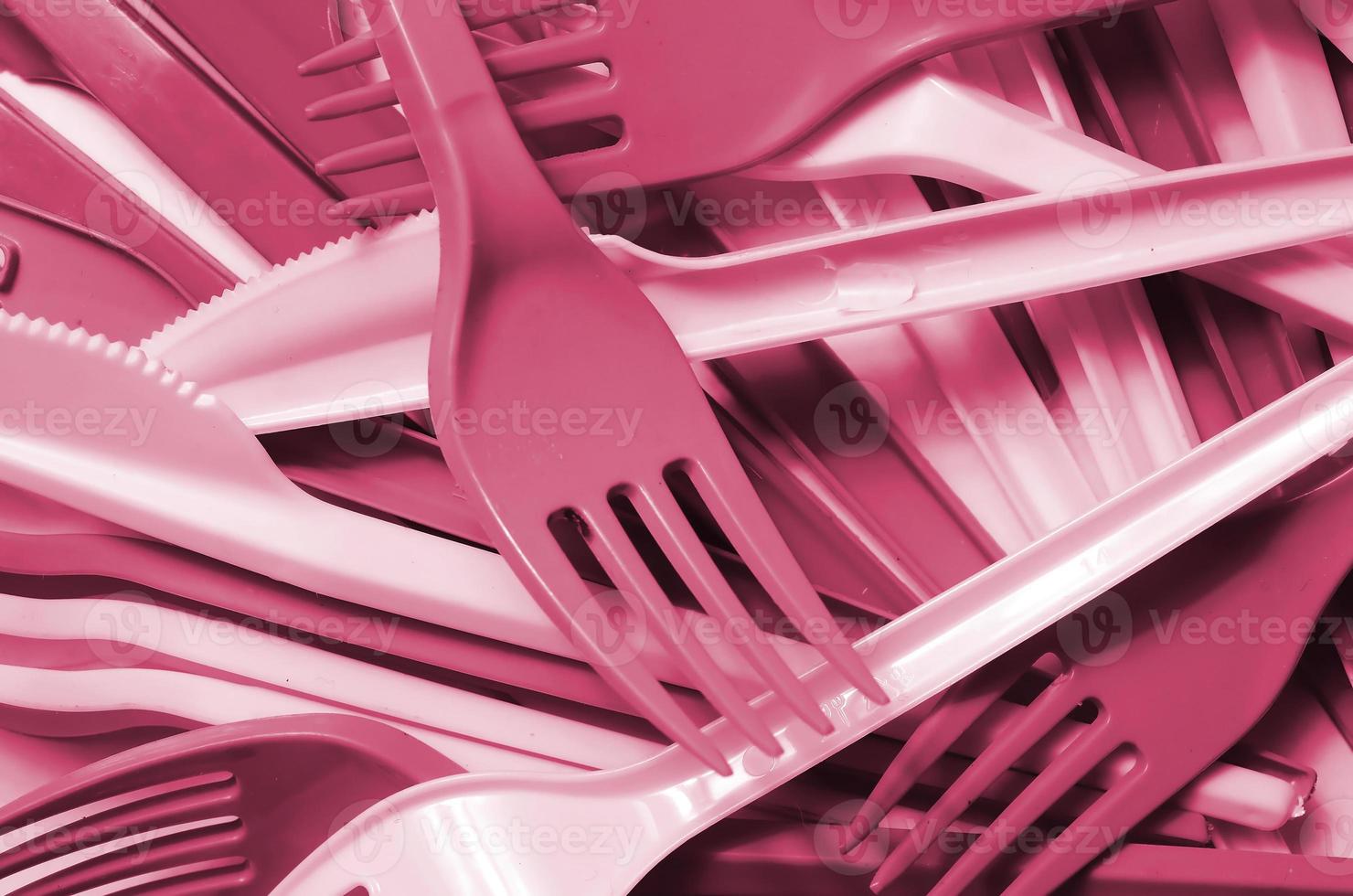 Pile of used plastic kitchenware appliances Image toned in Viva Magenta, color of the 2023 year photo