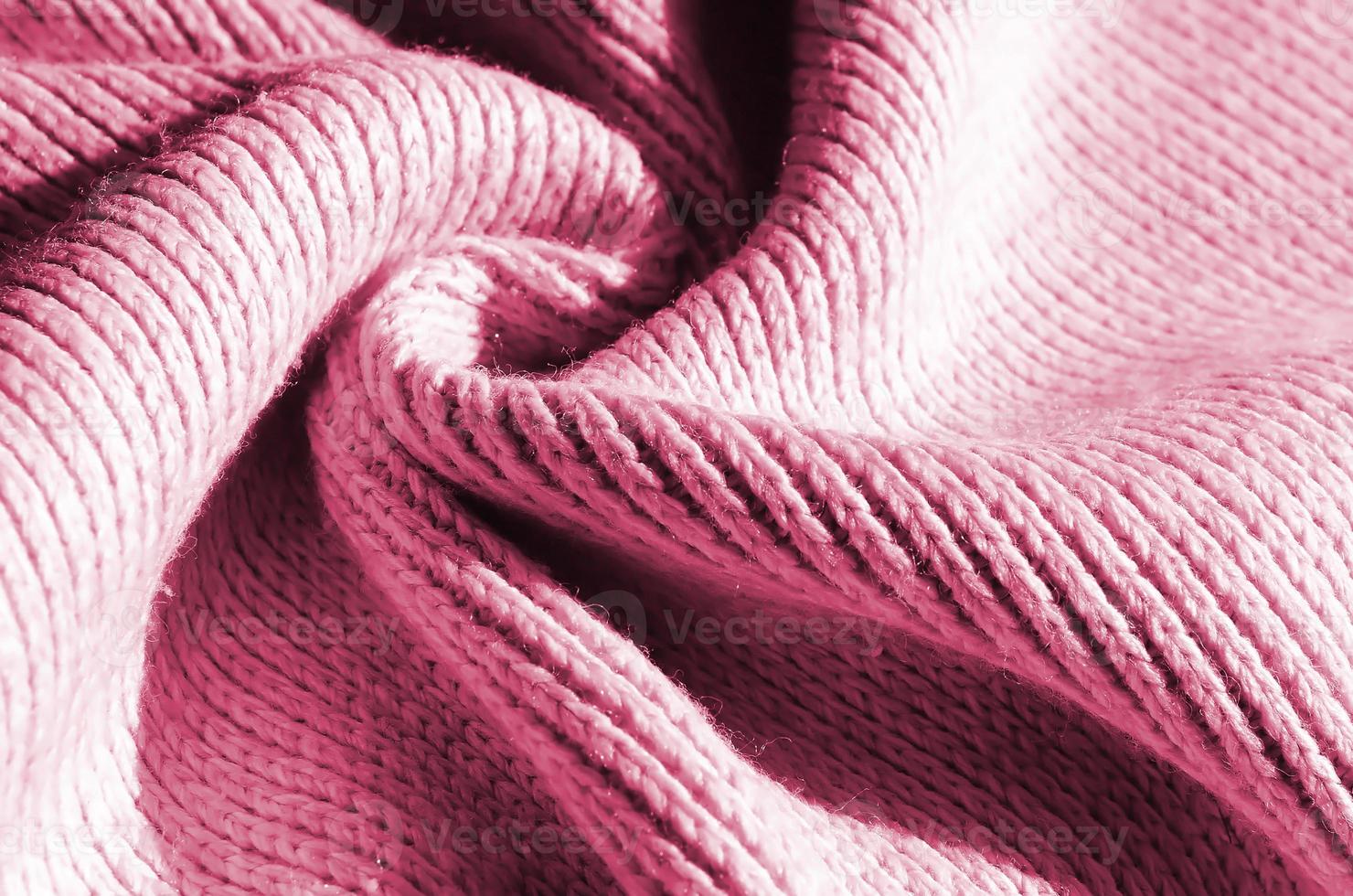 Fabric texture of a soft yellow knitted sweater. Macro image of the structure of bindings in yarns Image toned in Viva Magenta, color of the year photo