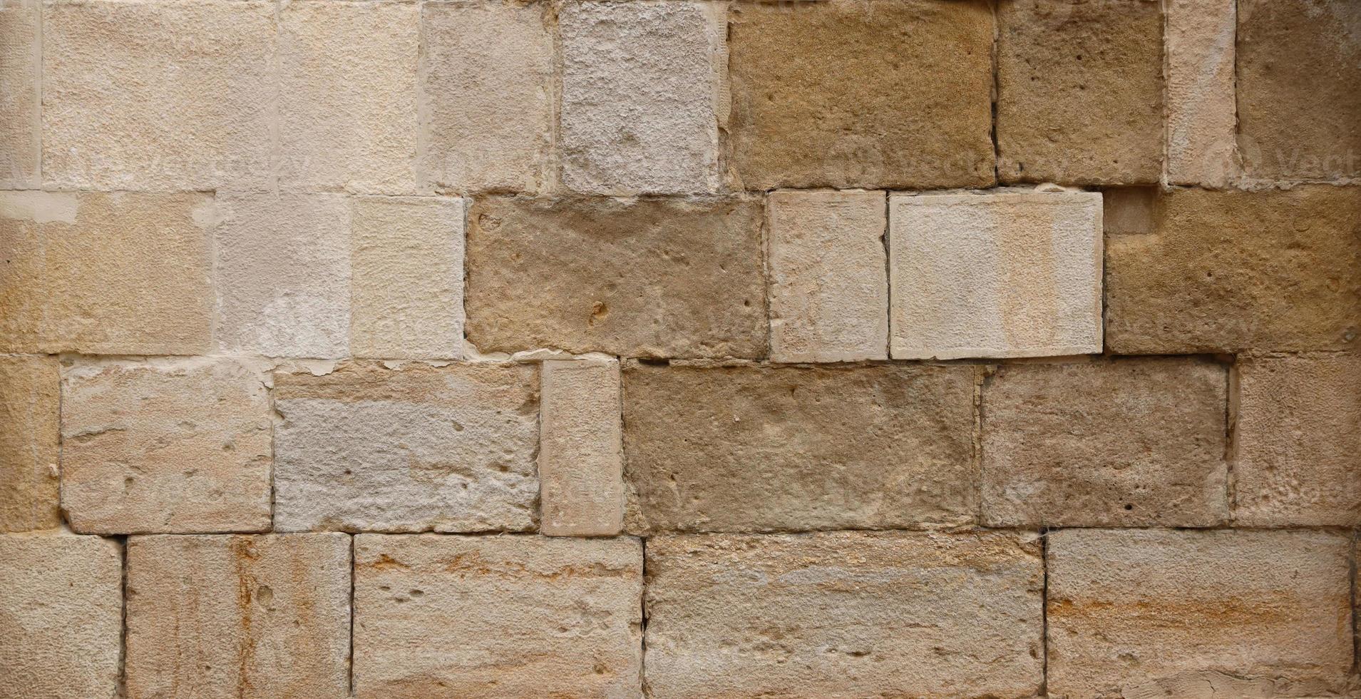 Texture of stone wall with many big brown stones photo