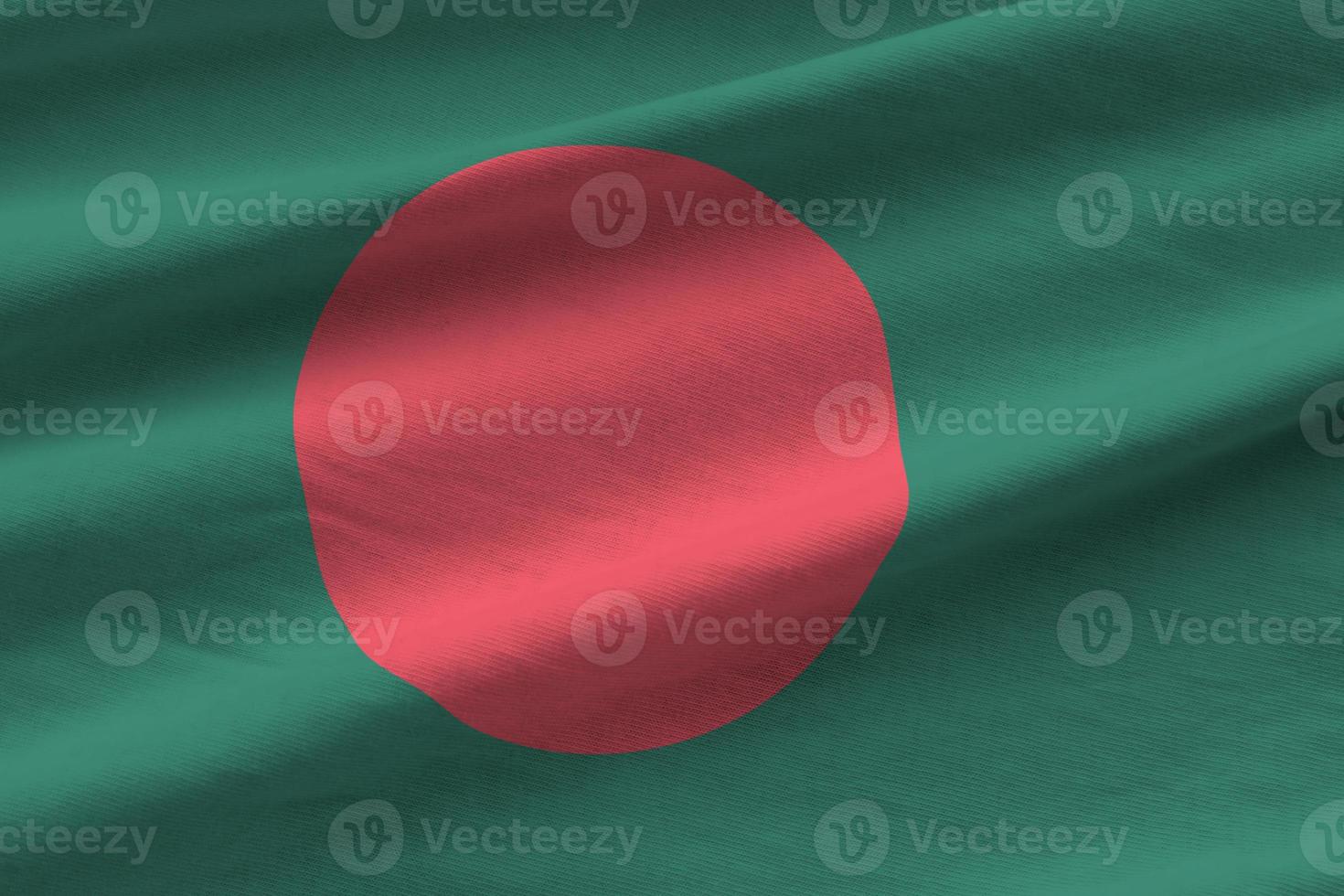 Bangladesh flag with big folds waving close up under the studio light indoors. The official symbols and colors in banner photo