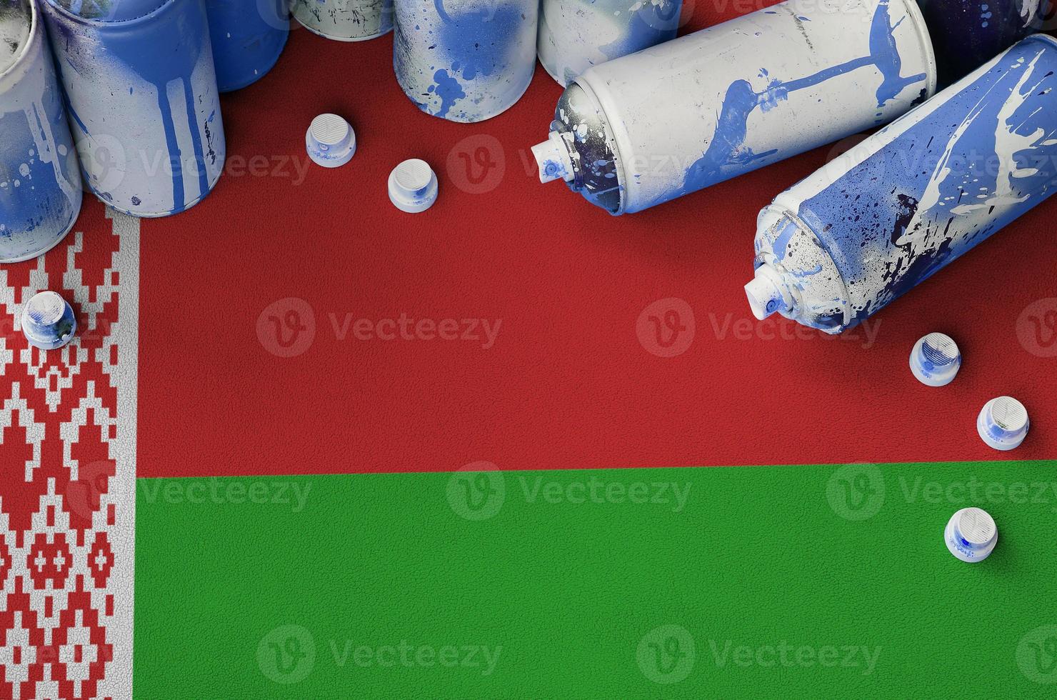Belarus flag and few used aerosol spray cans for graffiti painting. Street art culture concept photo