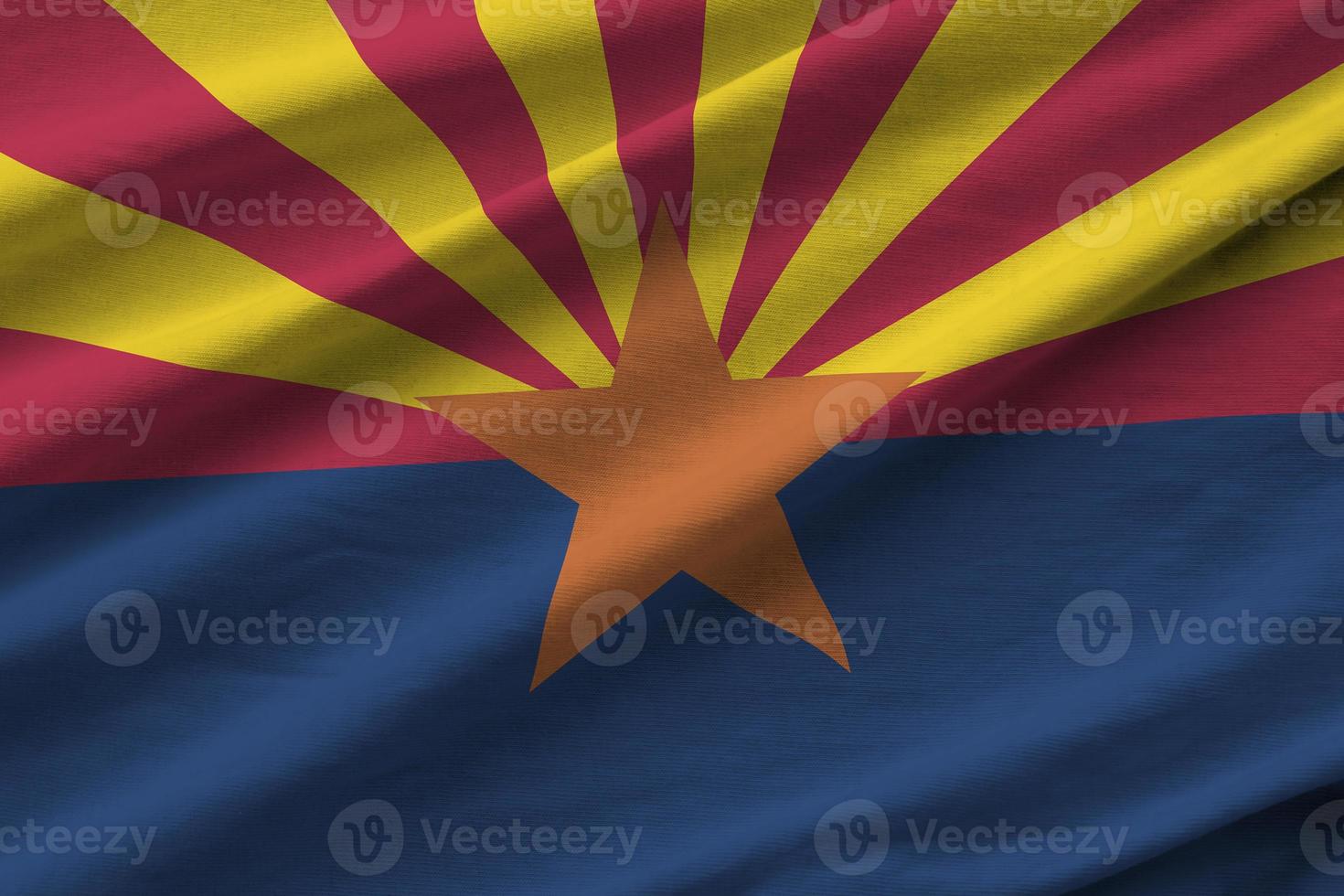 Arizona US state flag with big folds waving close up under the studio light indoors. The official symbols and colors in banner photo