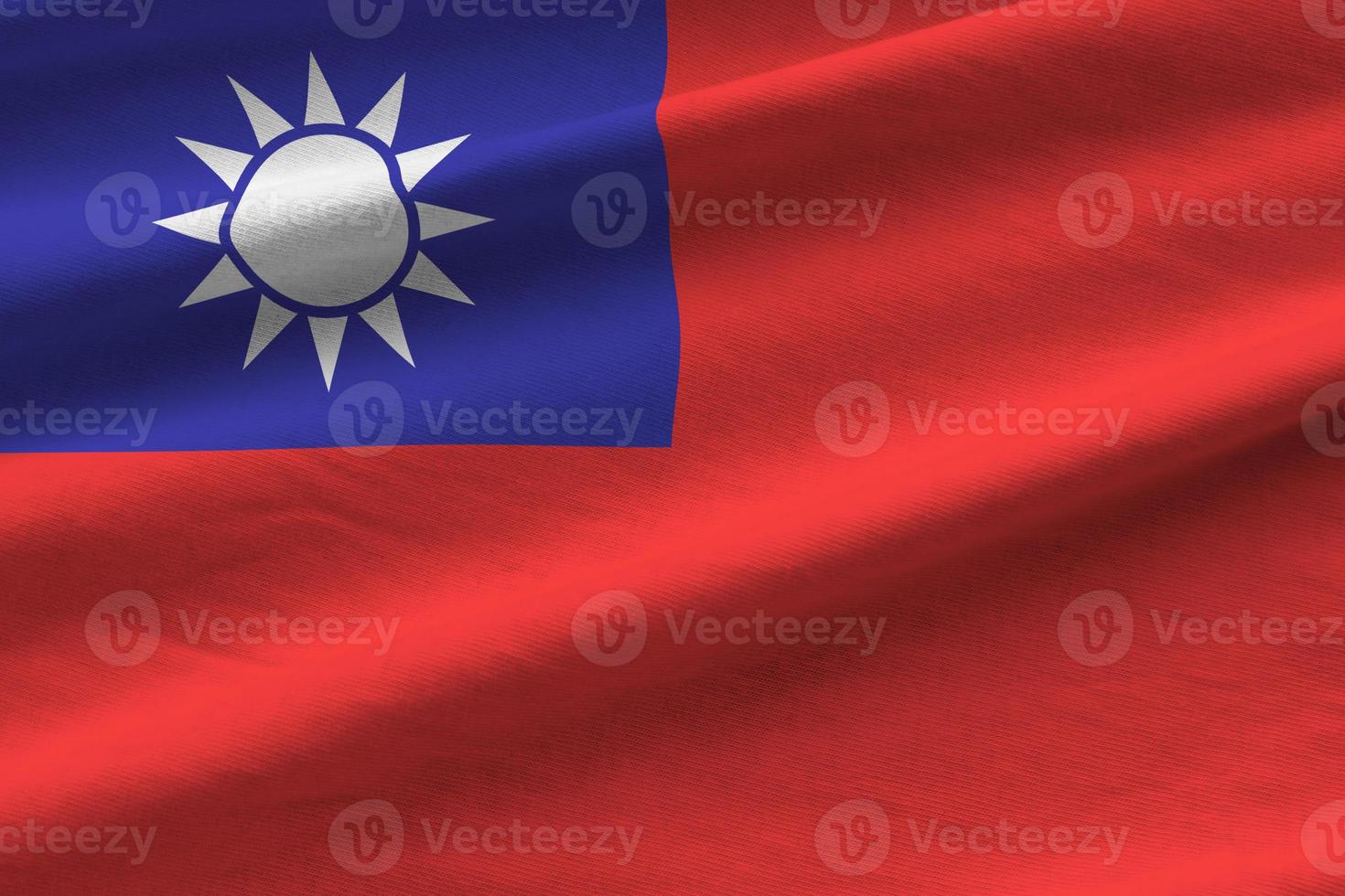 Taiwan flag with big folds waving close up under the studio light indoors. The official symbols and colors in banner photo