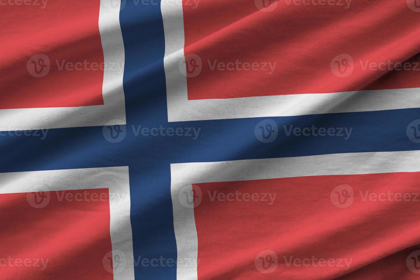 Norway flag with big folds waving close up under the studio light indoors. The official symbols and colors in banner photo