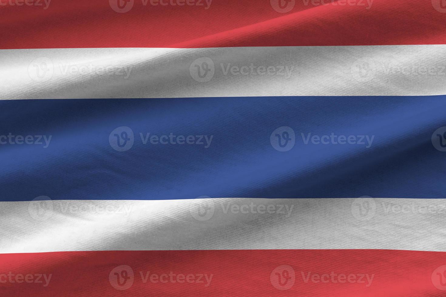 Thailand flag with big folds waving close up under the studio light indoors. The official symbols and colors in banner photo
