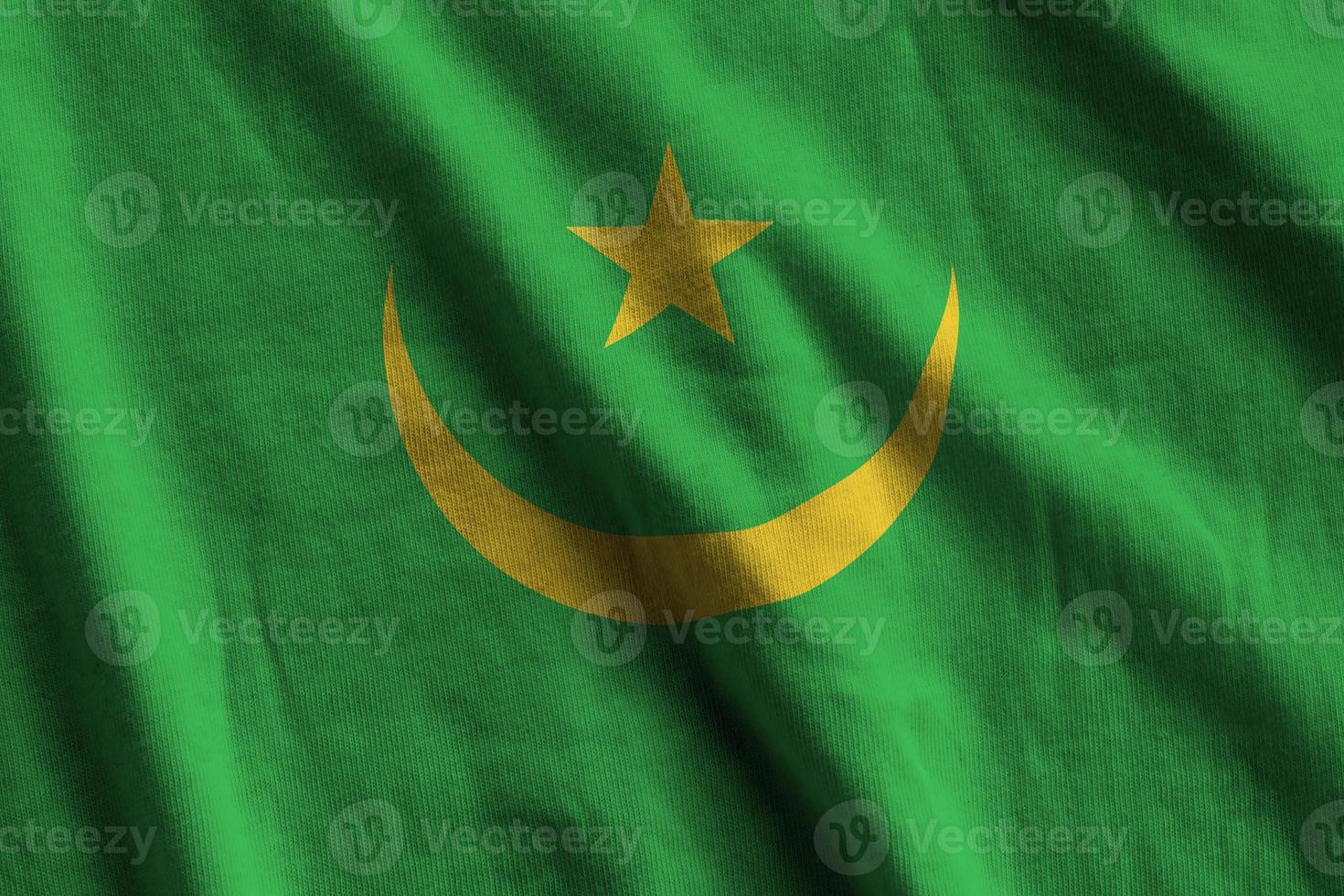 Mauritania flag with big folds waving close up under the studio light indoors. The official symbols and colors in banner photo