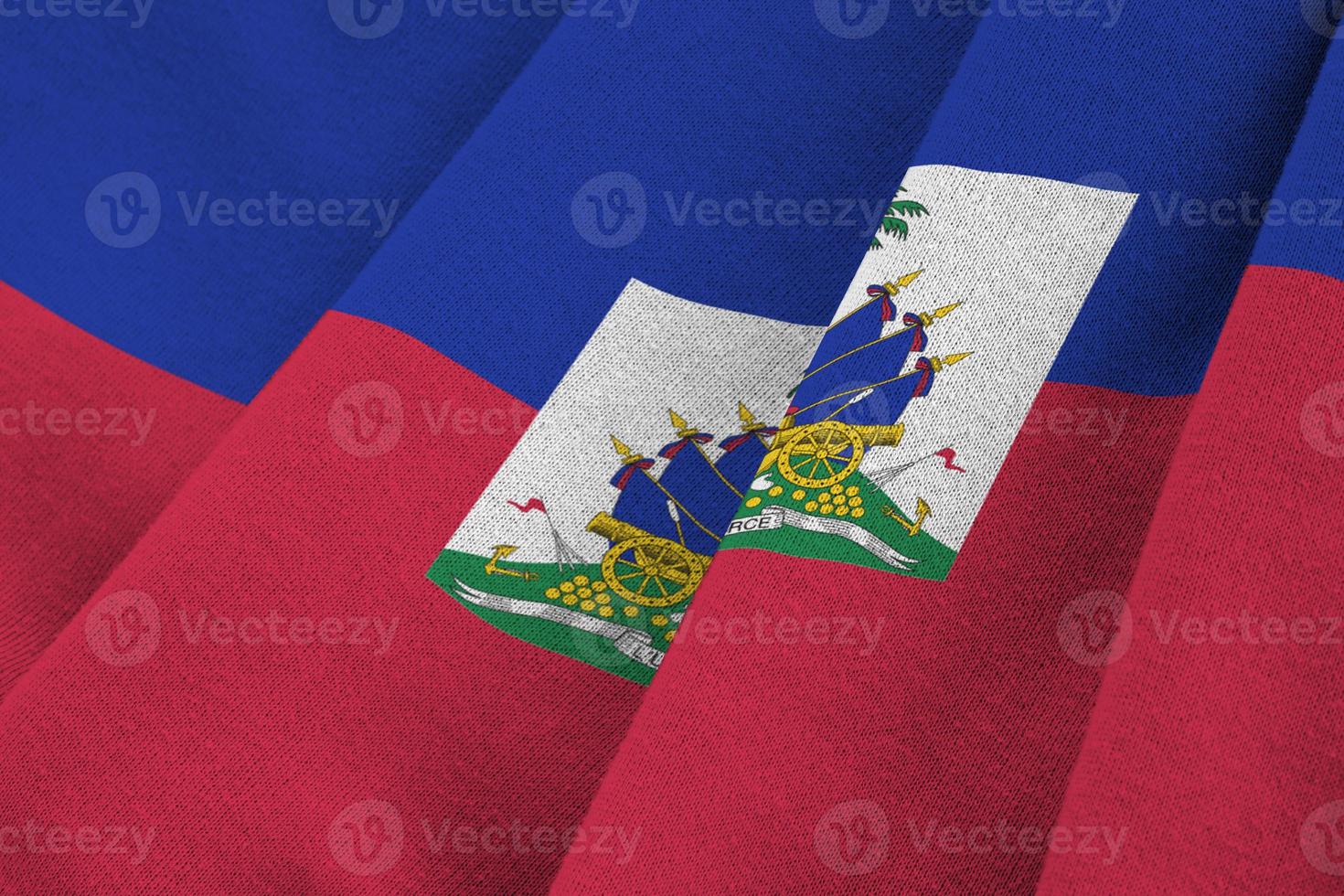 Haiti flag with big folds waving close up under the studio light indoors. The official symbols and colors in banner photo