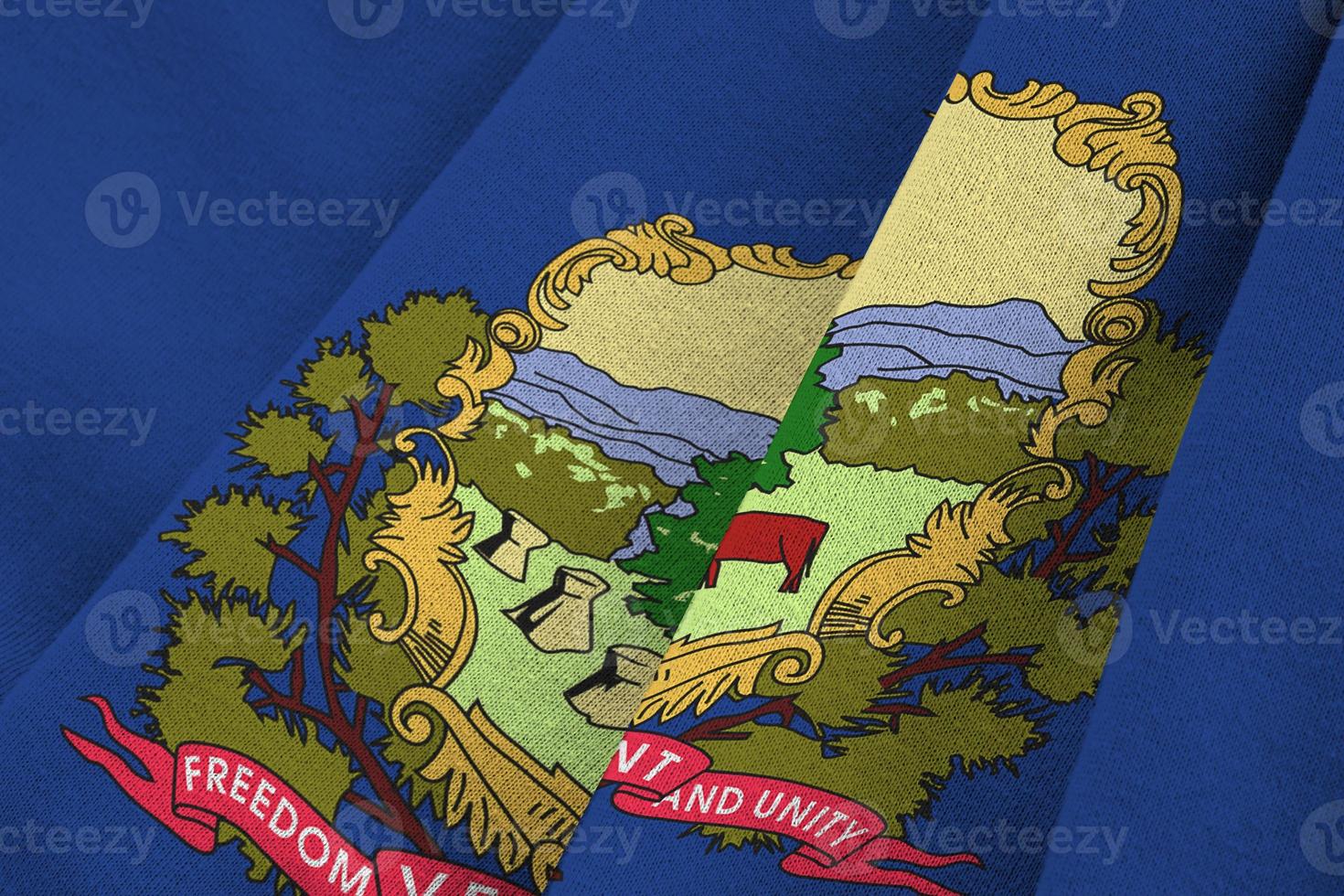 Vermont US state flag with big folds waving close up under the studio light indoors. The official symbols and colors in banner photo