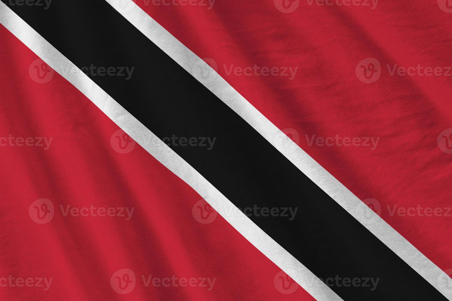 Trinidad and Tobago flag with big folds waving close up under the studio light indoors. The official symbols and colors in banner photo
