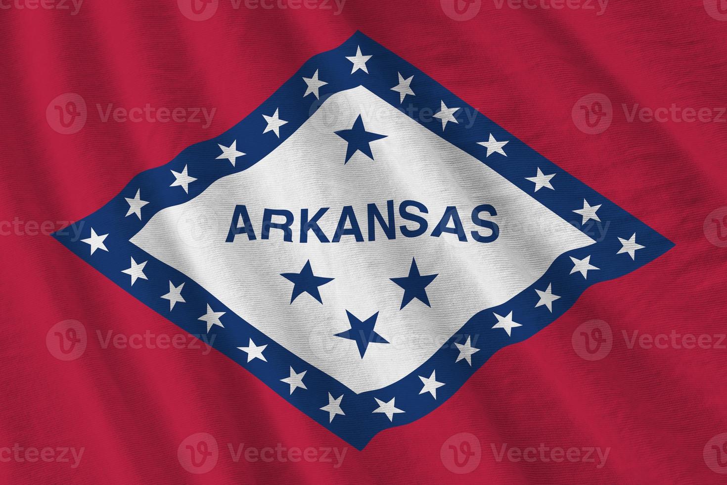 Arkansas US state flag with big folds waving close up under the studio light indoors. The official symbols and colors in banner photo