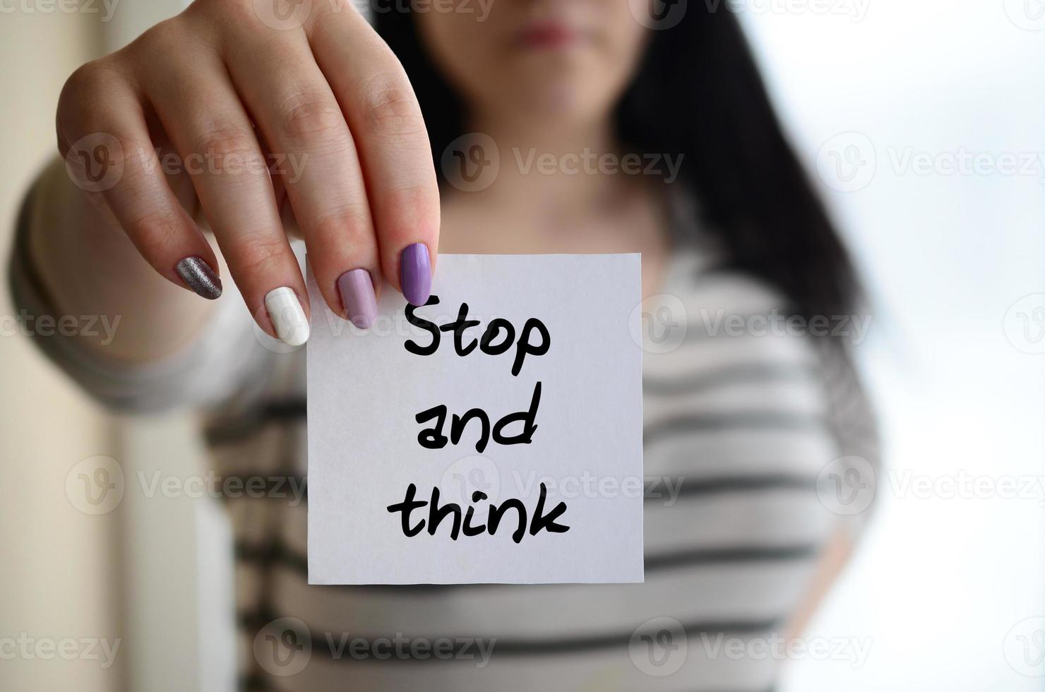 Young sad girl shows a white sticker. Caucasian brunette holding a ...