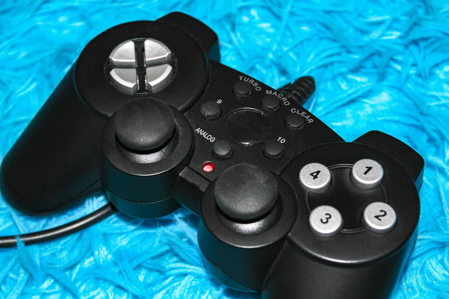 Leherheide Bremerhaven Germany 2010 Black game controller on blue background in Germany. photo