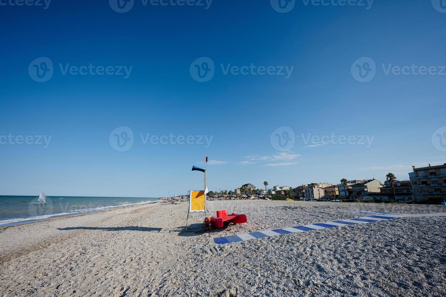 Red lifeguard rescue boat on beach of Adriatic sea Porto Sant Elpidio, Italy. photo