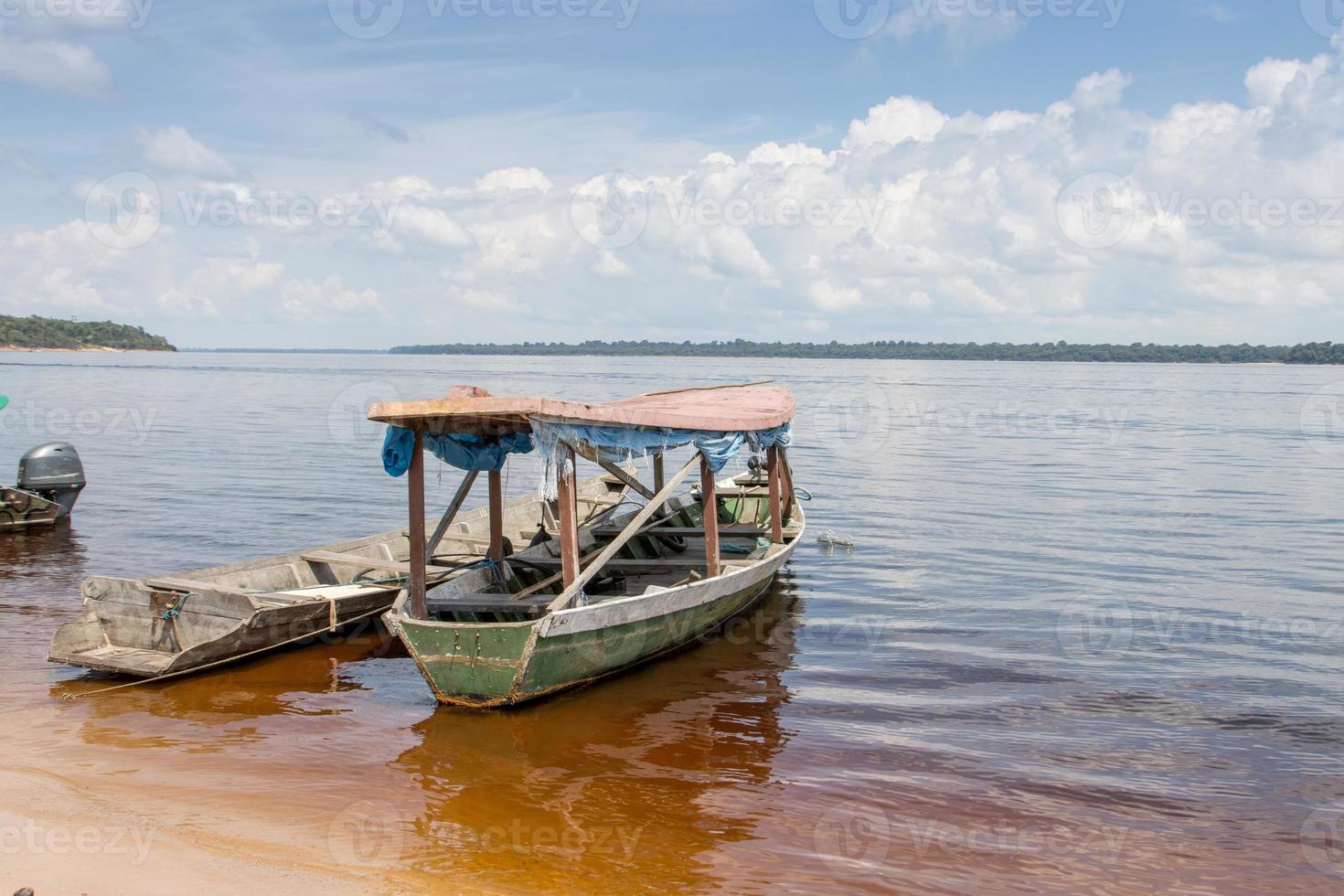 Old wooden passenger boat that are common docked on the shore of the Rio Negro in Airao , Brazil photo
