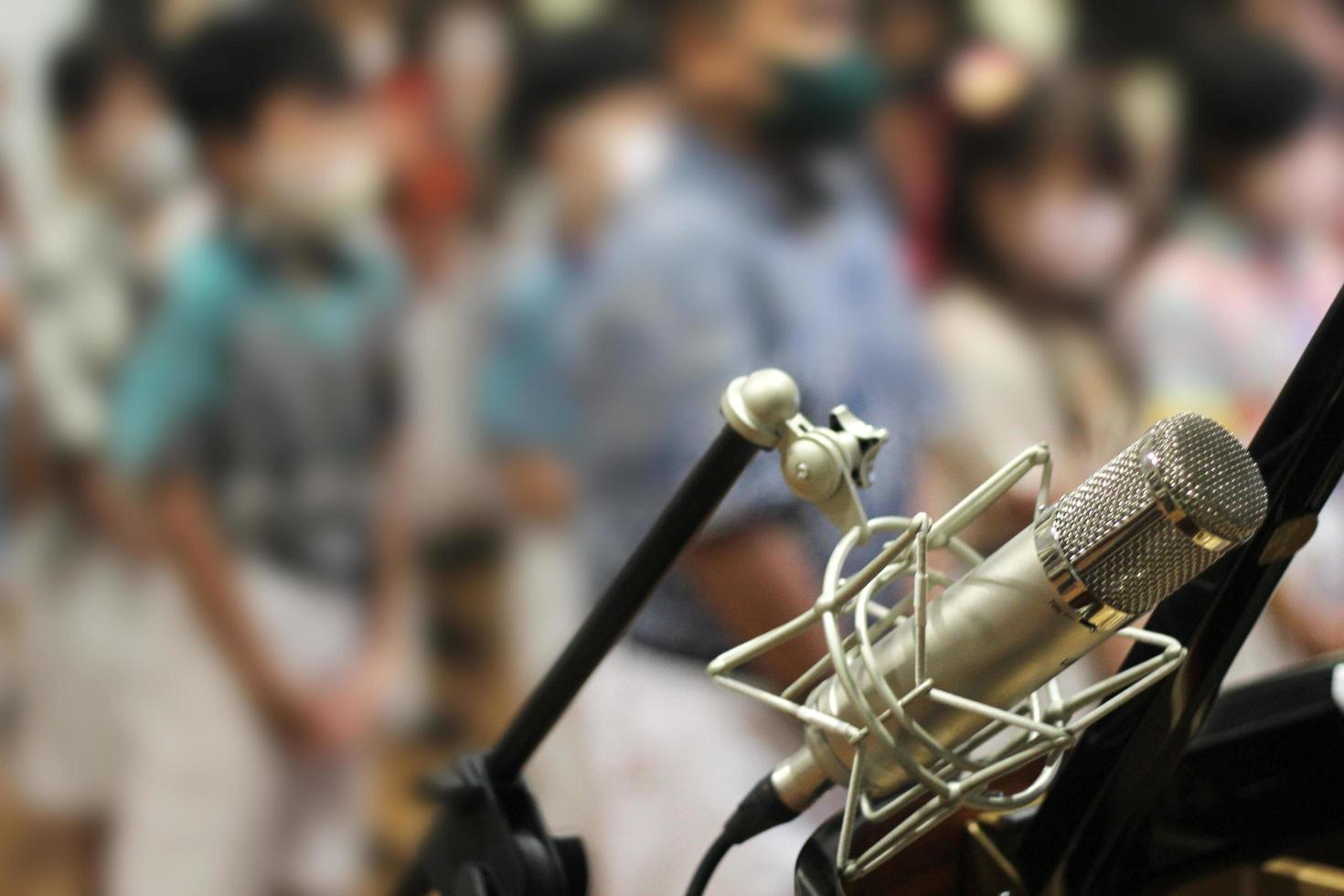 Live performance recording mic with children's background blur photo