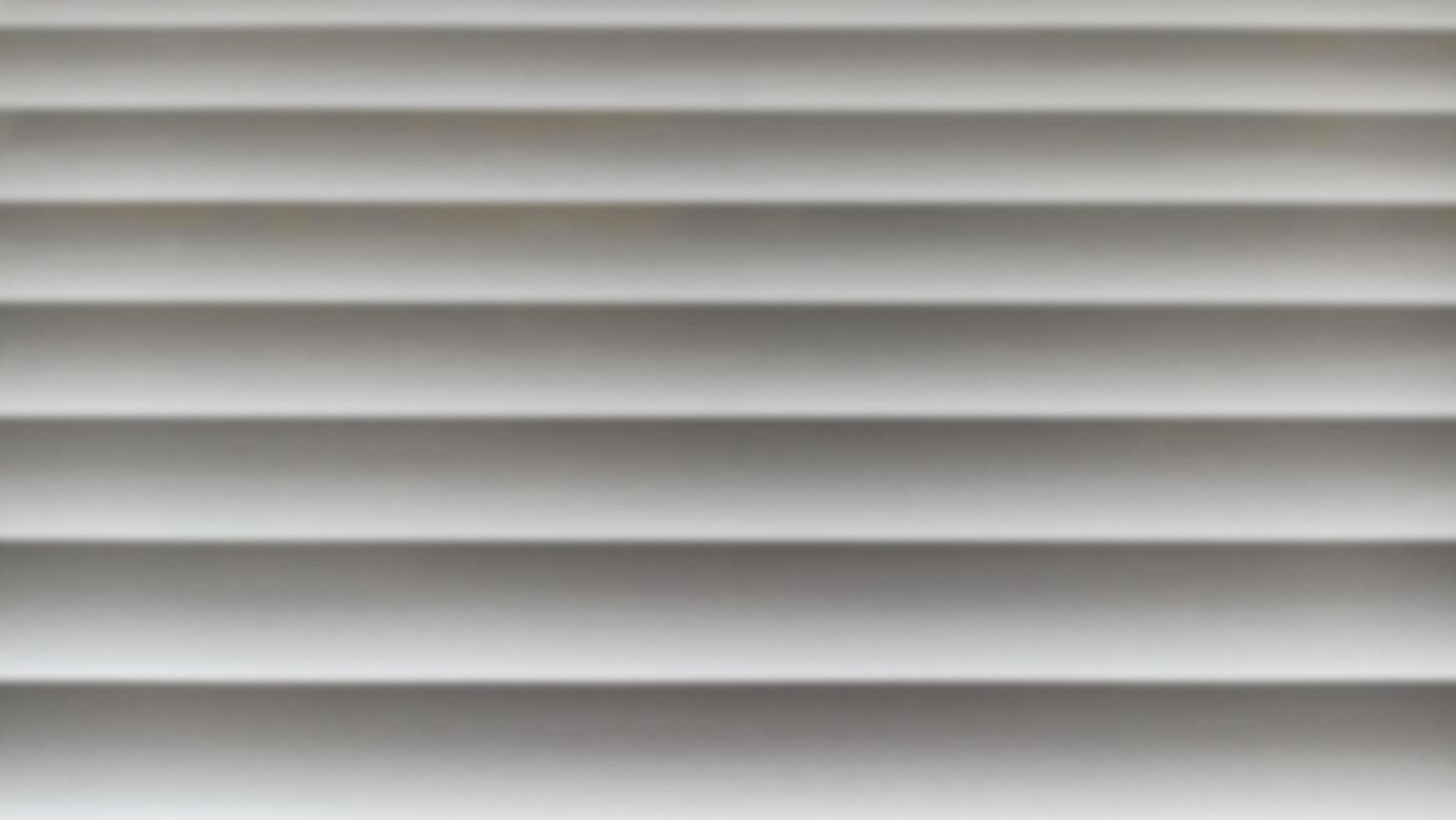 Window blinds with wavy gray striped background photo