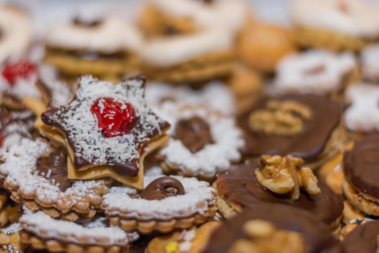 different tasty christmas cookies with white springles red cherry and nuts photo