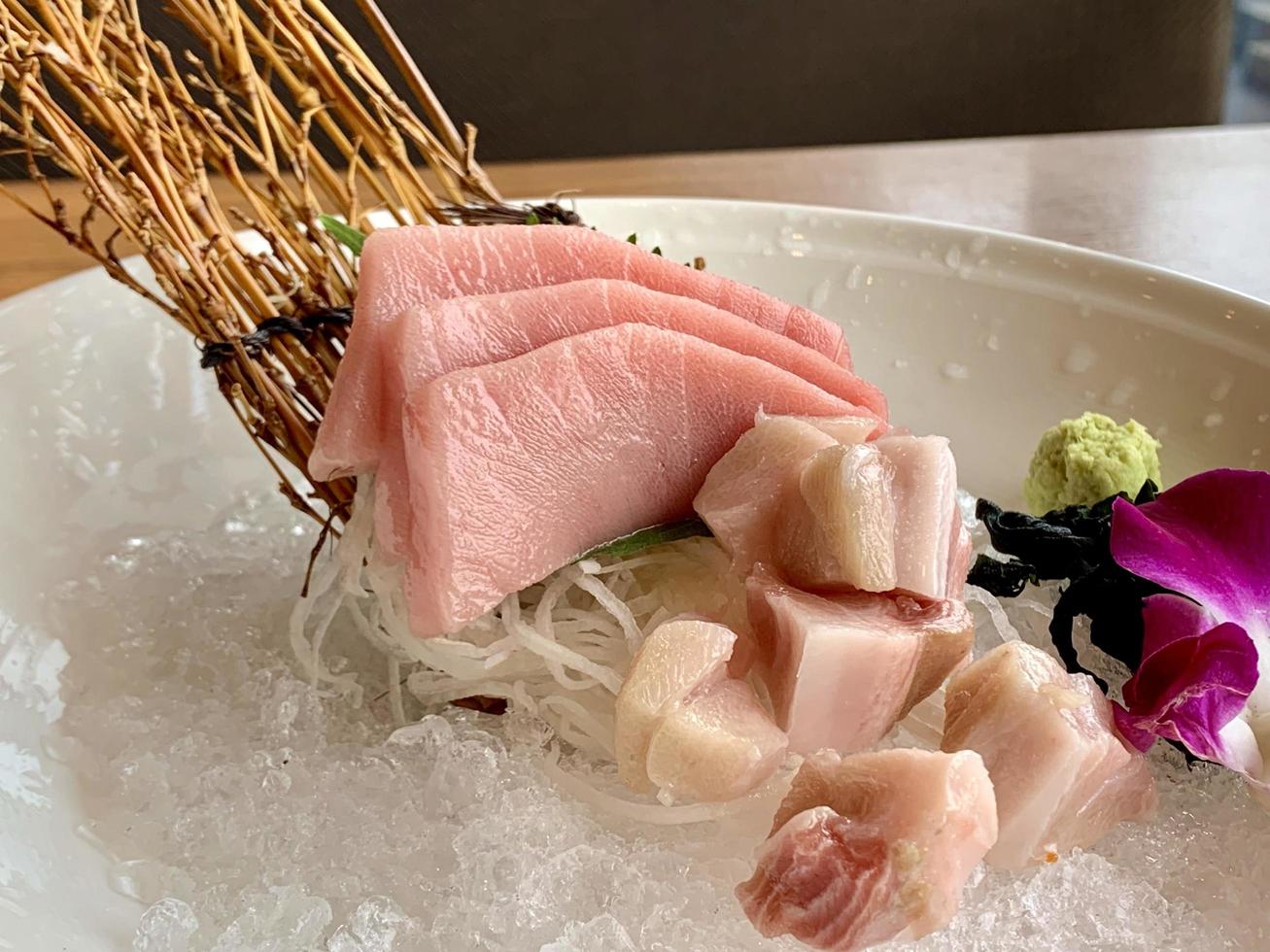 Various menus, sushi, sashimi, nigiri, pan fried pork and miso soup. Sashimi, chutoro sashimi, Japanese food chopsticks and wasabi on the black table, Japanese food style. blurs focus. photo