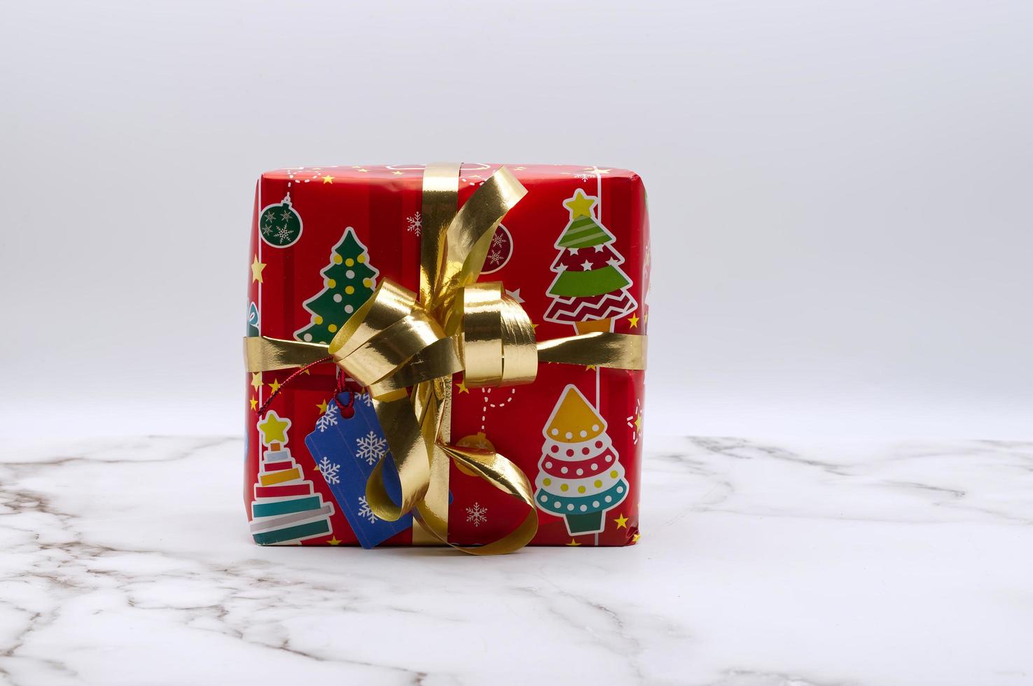 Christmas gift box isolated on marble background. Copy space for your text photo