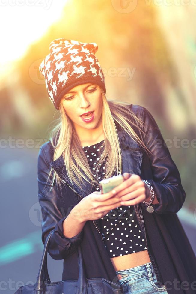 Teen with his smartphone photo