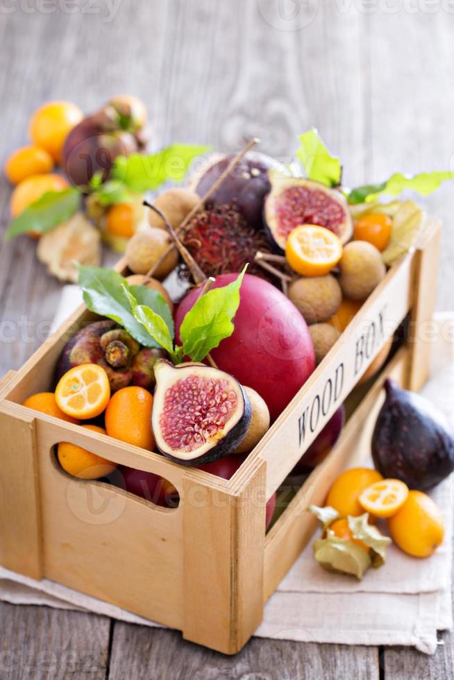 Exotic fruits in a wooden crate photo