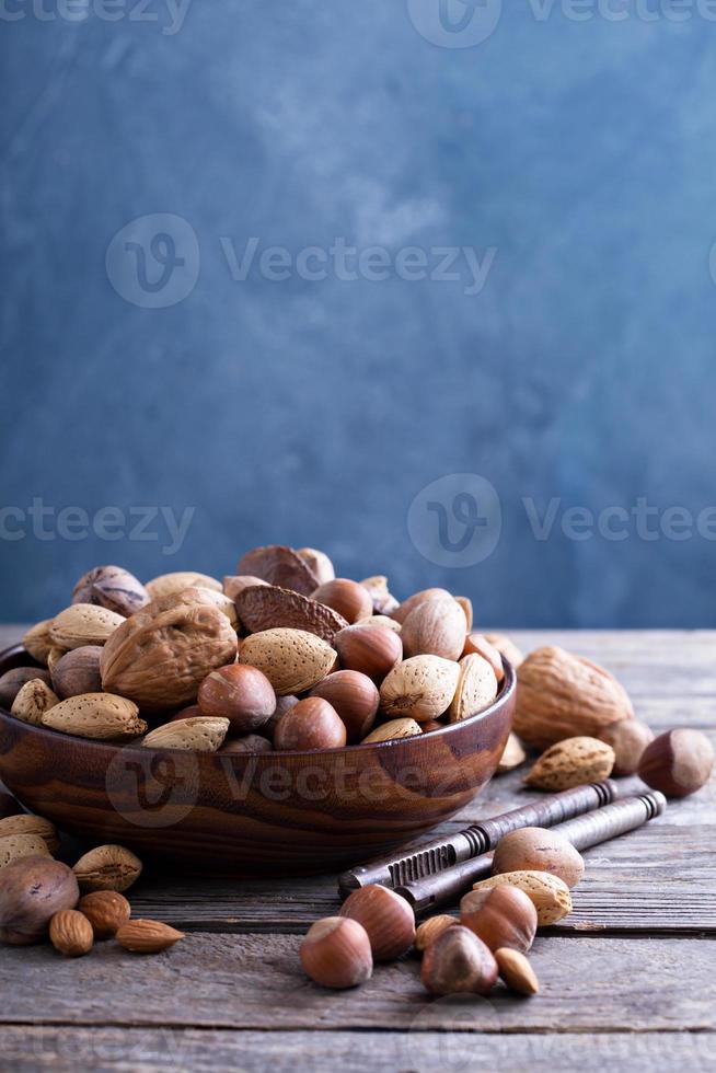 Variety of nuts with shells in a bowl photo