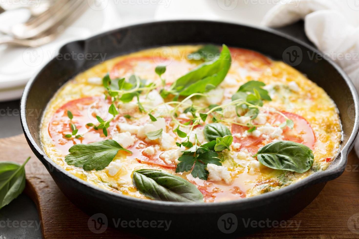 Frittata with tomatoes and feta cheese photo