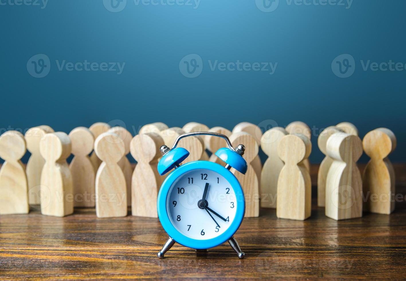 Alarm clock and a crowd of people. Time management. Hourly wages, strict work limits and break time. Planning and forecasting. Employee performance monitoring system, Organization of business photo