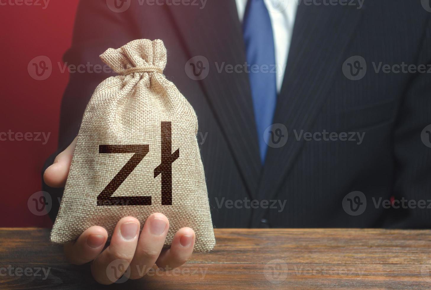 Man gives a polish zloty money bag. Loan issuance. Investments, financing Lobbying. Funding. Accounting, tax payment. Earnings and profits. Financial support, leasing. photo