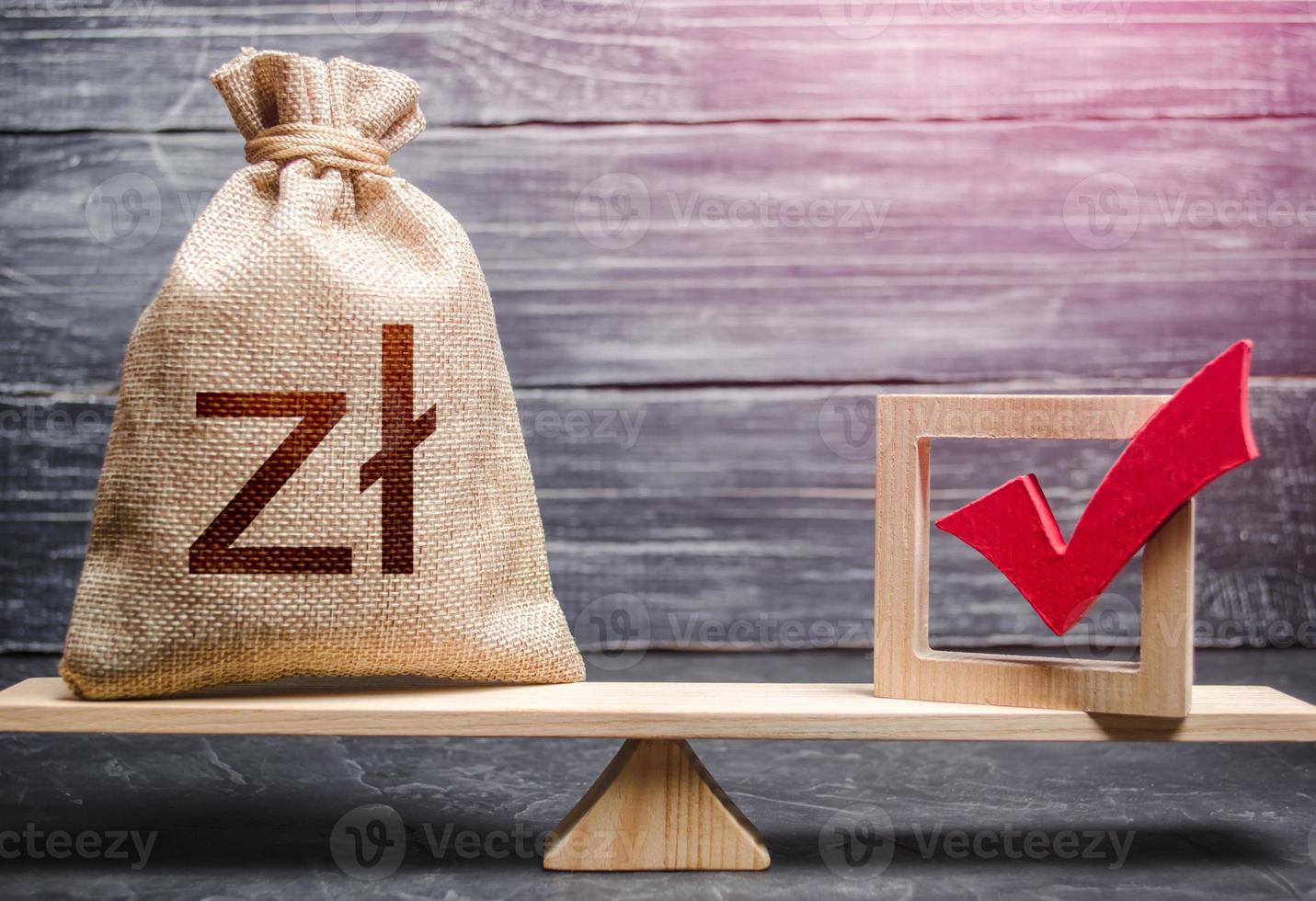 Red vote tick and a polish zloty money bag on scales. Estimating cost of making a decision and consequences in the future. Concept of lobbying for decisions and laws. Corruption risks. photo