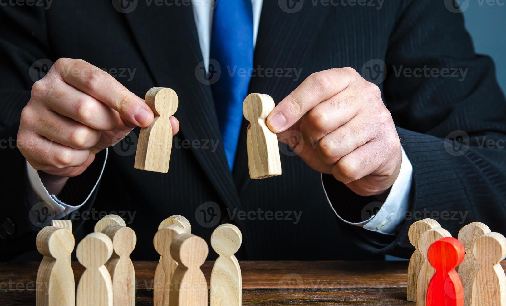 A businessman evaluates candidates for employment. Staff and Human Resource Management. Team building. Personnel selection. Staffing, recruiting and training workers. Appointment to posts. Employment. photo