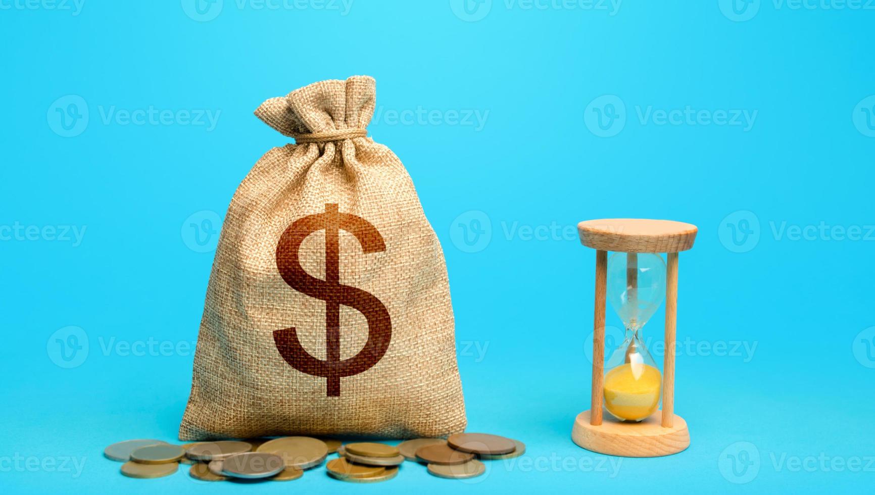 Dollar money bag and hourglass. Placing a deposit in the bank. Profitability and return on investment. Time for paying taxes. Pension savings. Customer loyalty program. Mortgage loan photo