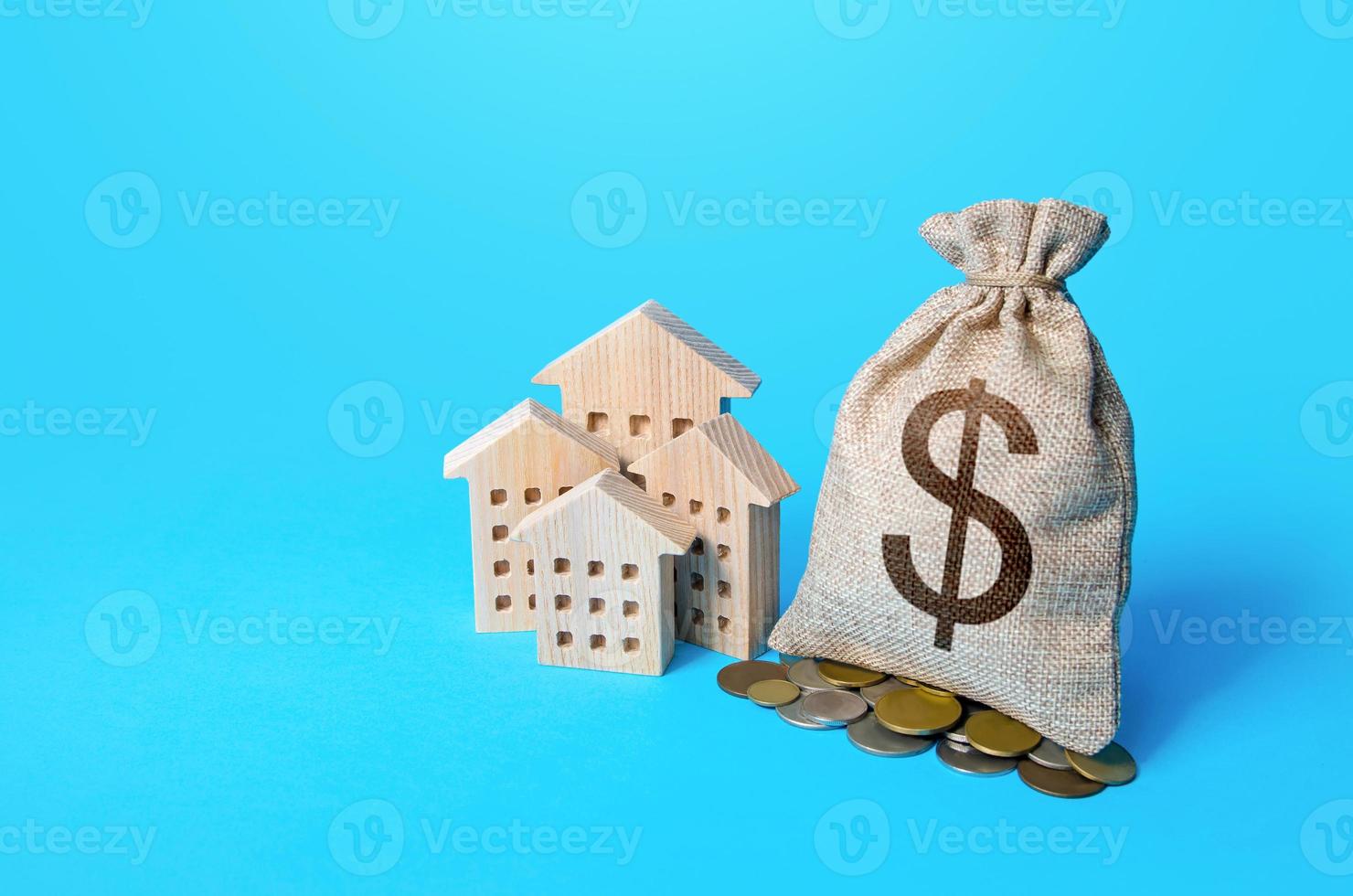 Houses and dollar money bag. Real estate investment and rental business. Increasing property value. Fair market price. Home taxation. Residential or commercial property income. Municipal budget. photo